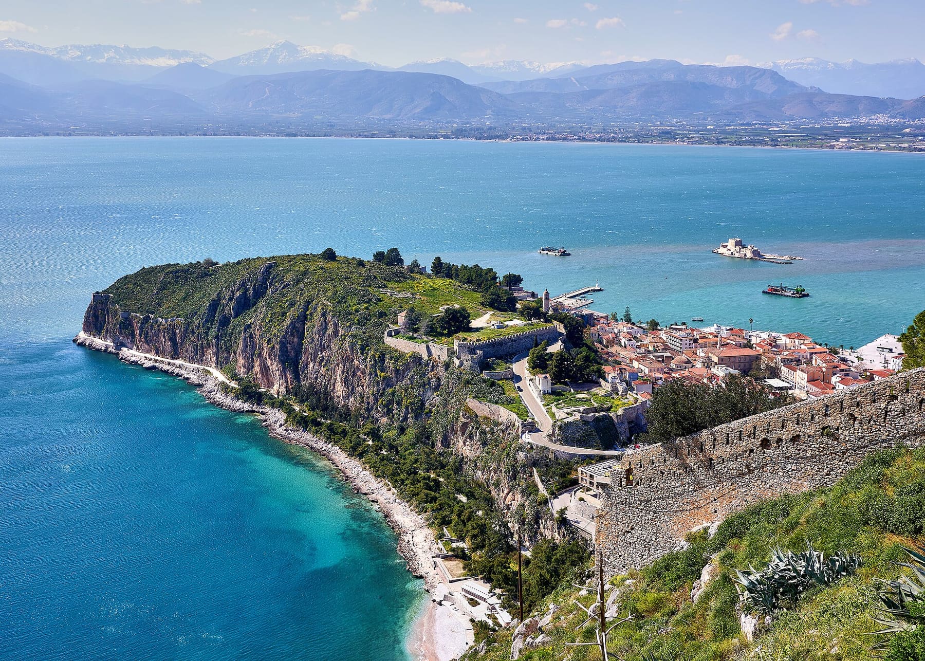 Nafplio’s old town and the Akronafplia headland seen from the Palamidi fortress, with the Bourtzi castle in the blue Argolic Gulf