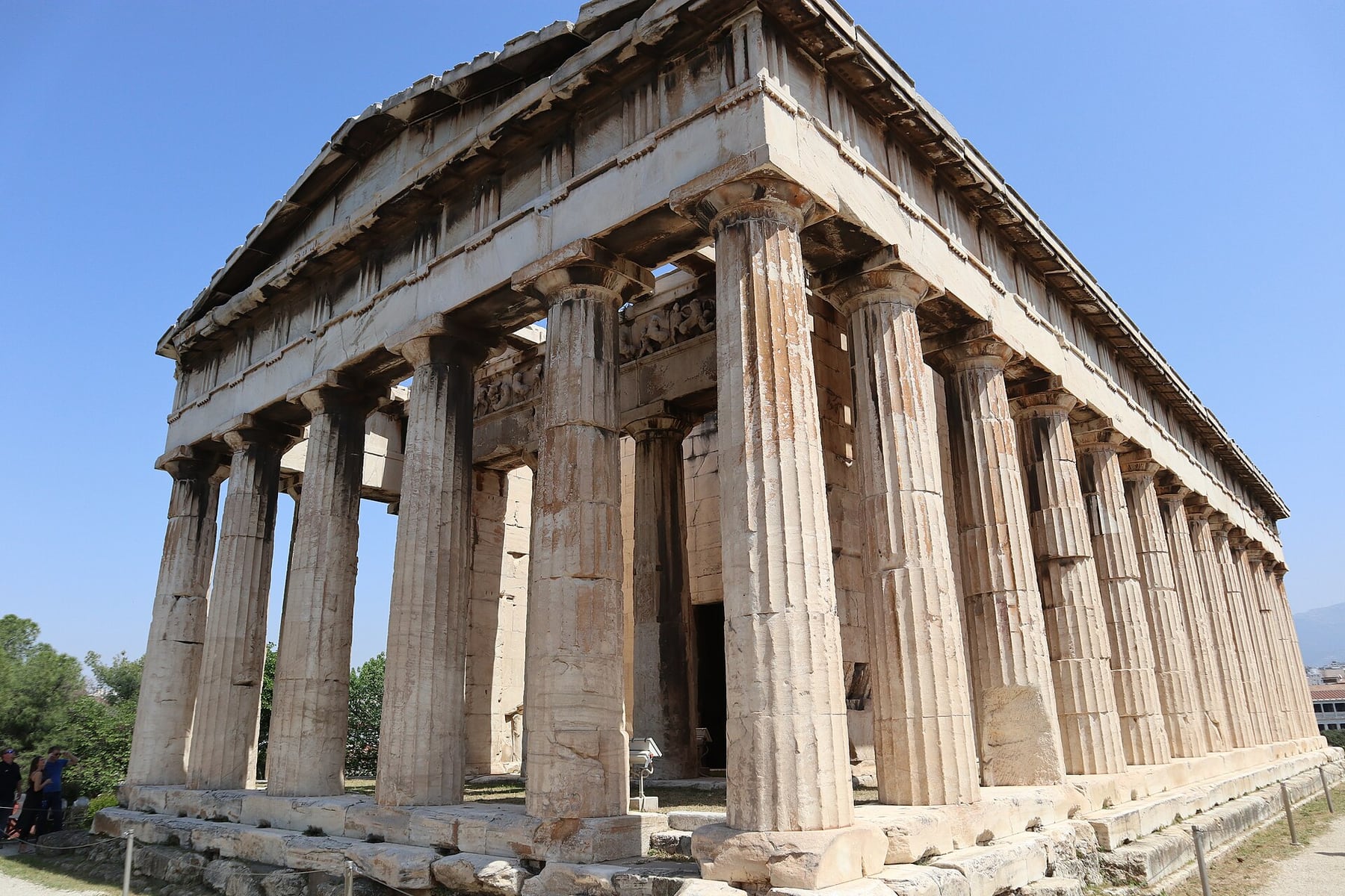 The Doric columns of the Temple of Hephaestus in the Ancient Agora of Athens under a clear blue sky