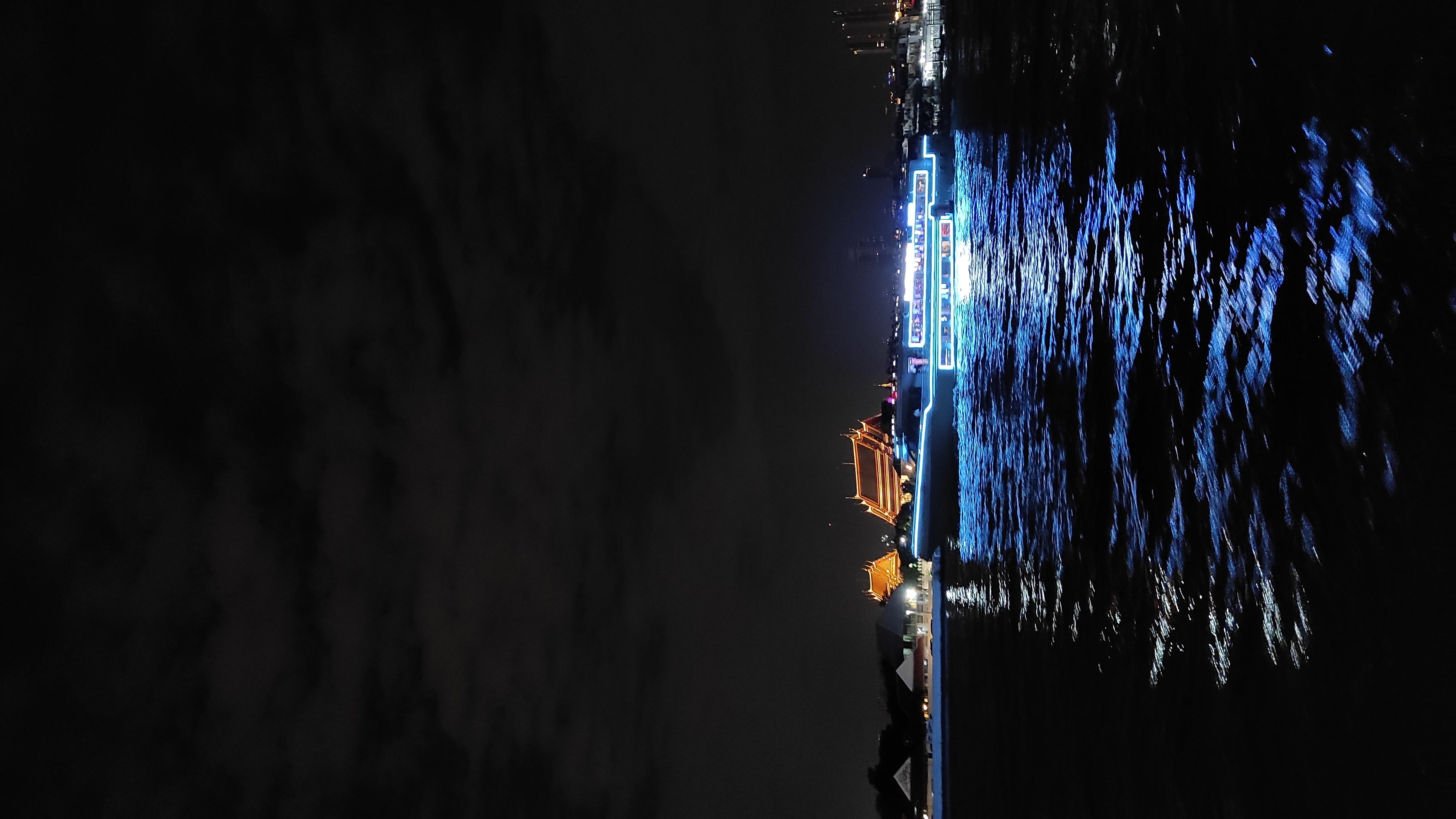 A river cruise boat lit up on the Chao Phraya at night, the kind of dinner cruise that closes out this one-day route