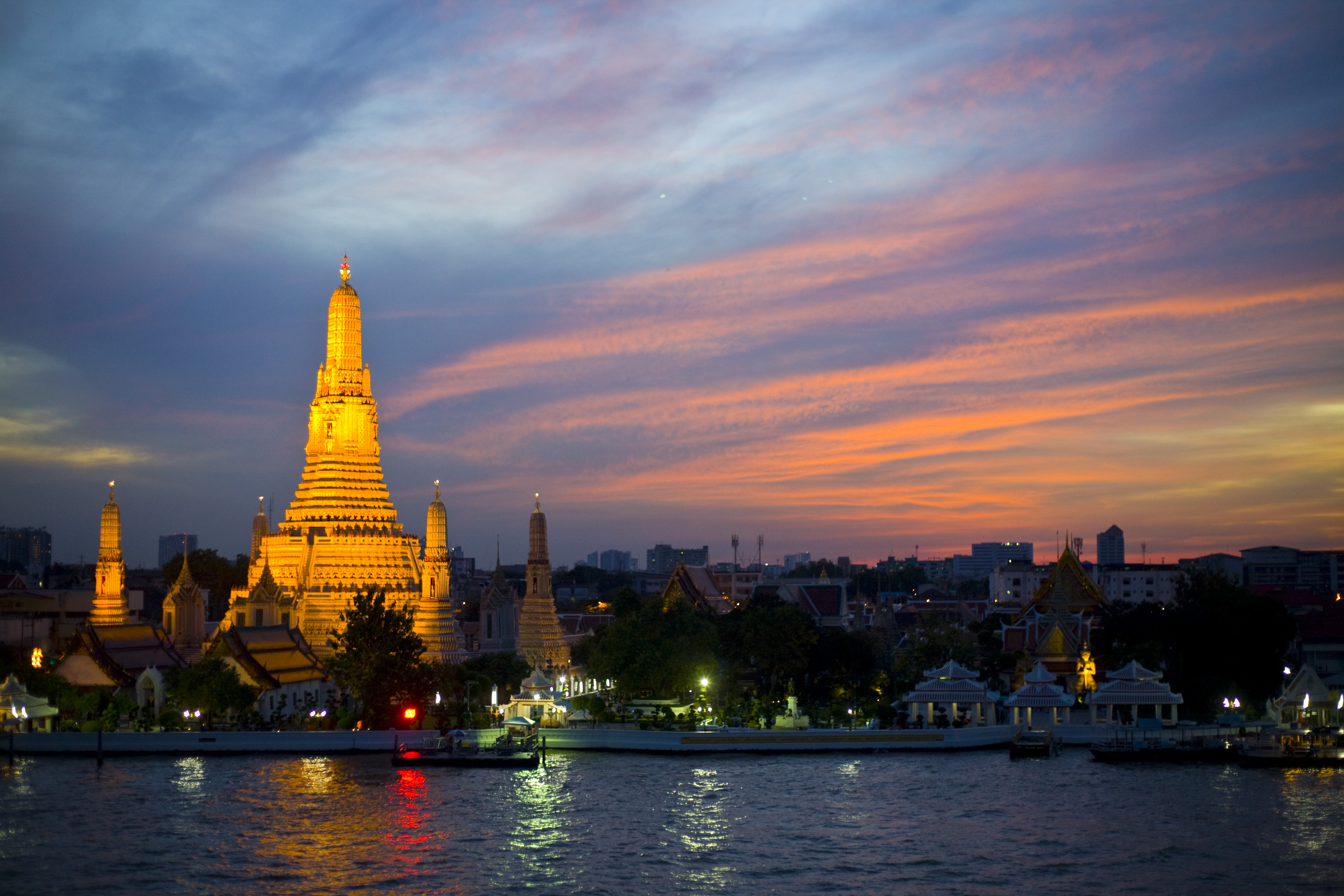 The Chao Phraya riverfront and Wat Arun at dusk, Bangkok