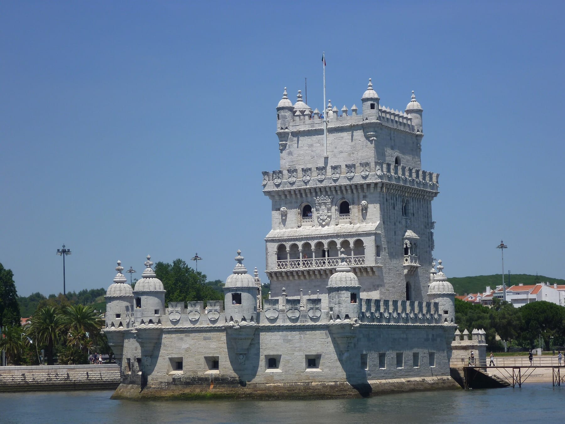 The white limestone Belém Tower seen from the Tagus, with its Manueline balconies, corner turrets and battlements above the river, one of the three ticketed visits on this page