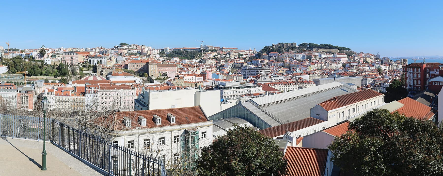View over the rooftops of Baixa to Castelo de São Jorge from the Miradouro de São Pedro de Alcântara, Lisbon